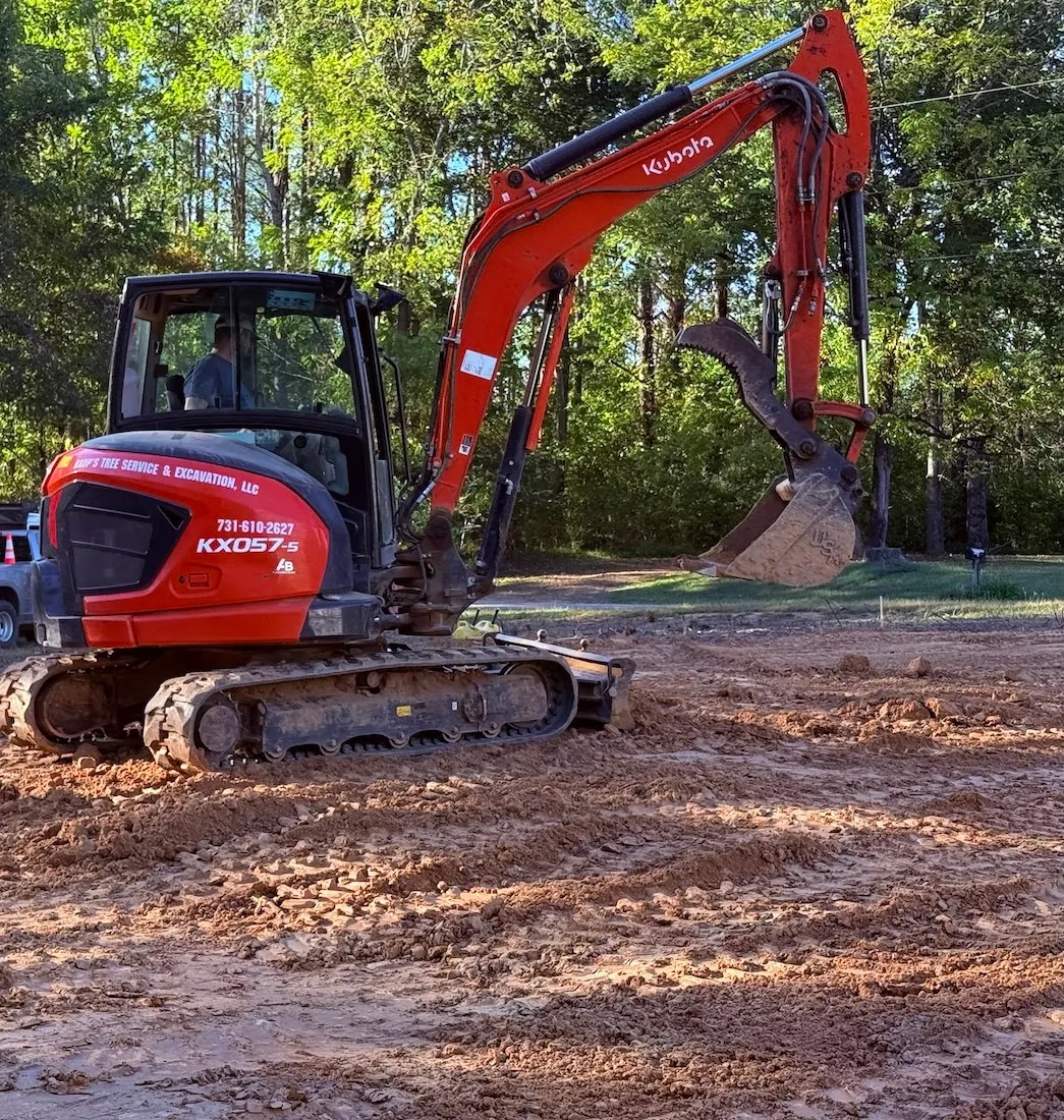 Red excavator performing excavation work for Selmer TN homeowners