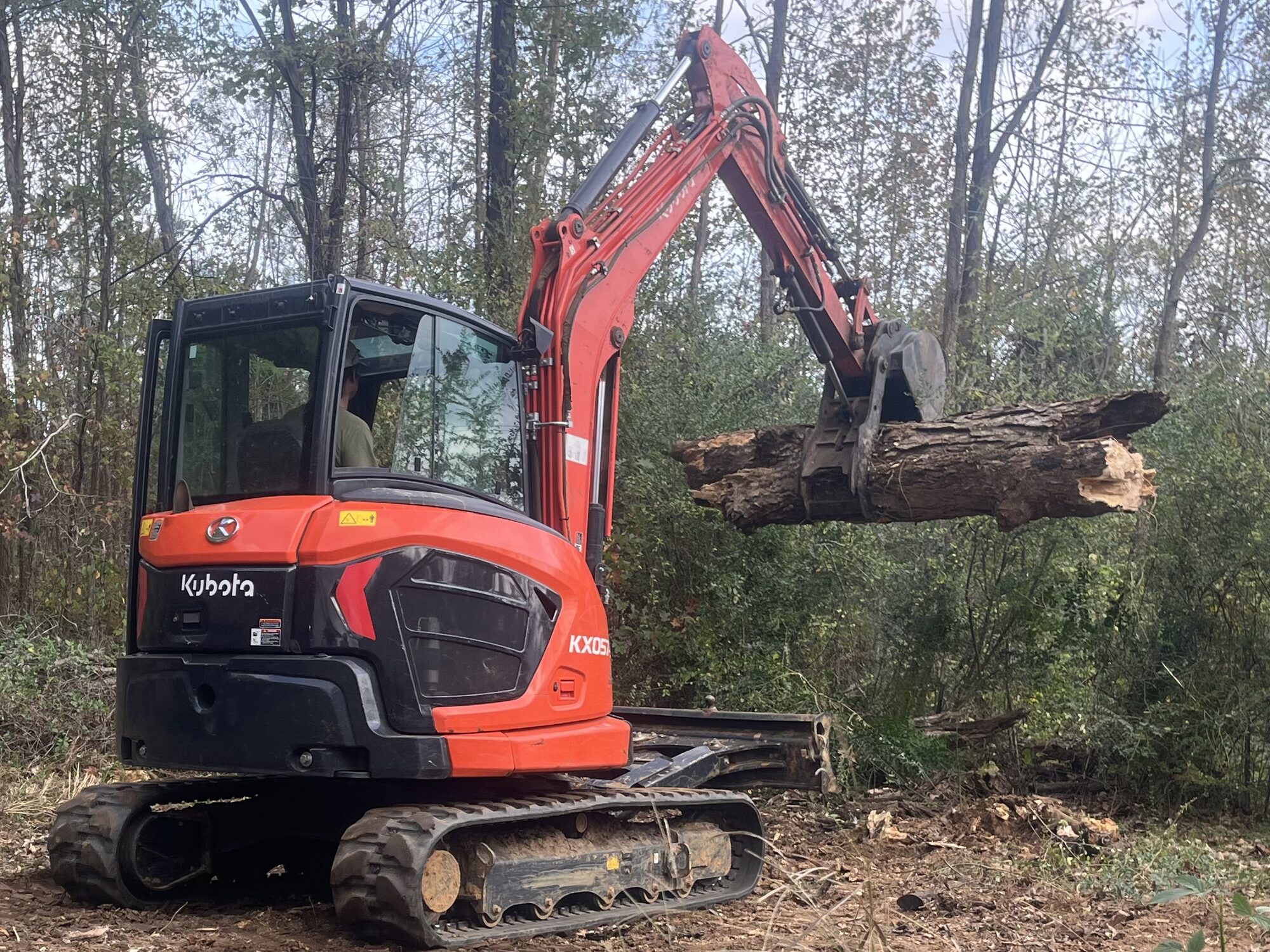 Hauling a downed trunk with excavator in McNairy County TN